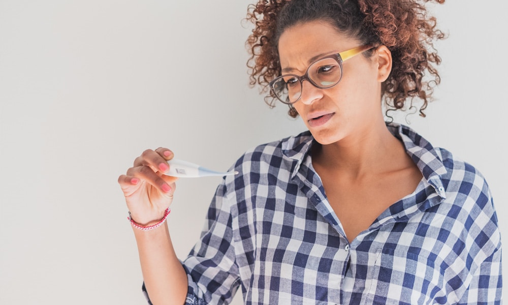 black woman looking at pregnancy test